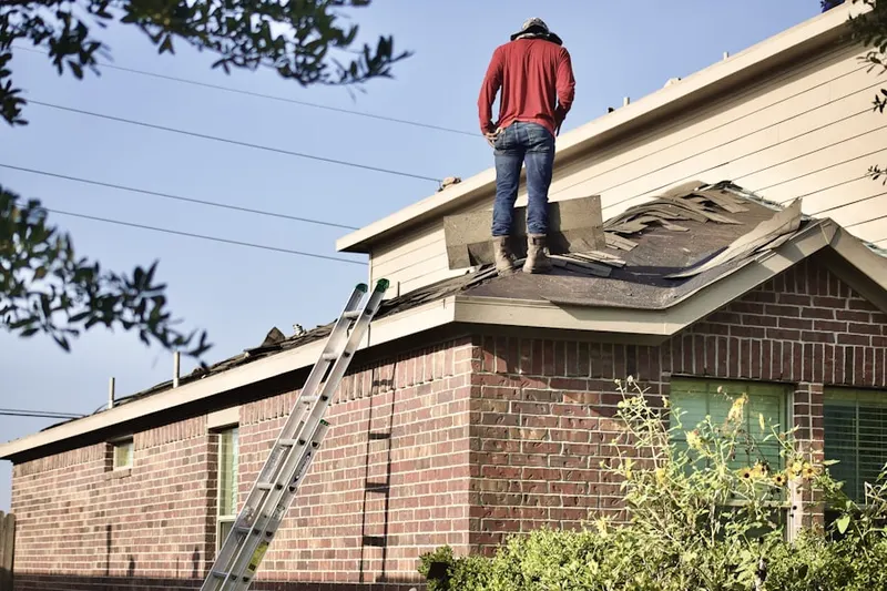Professional roofer working on a residential roof in English Meadows